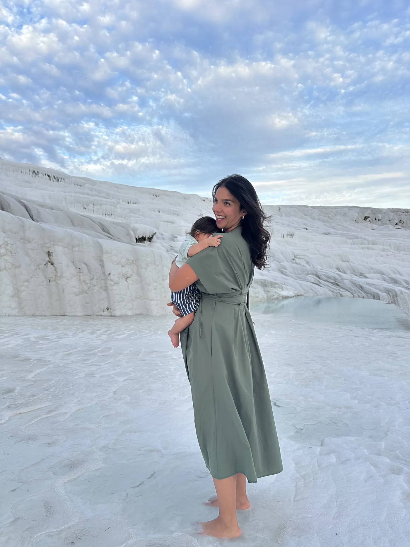 Monika exploring white terraces with her baby in her arms
